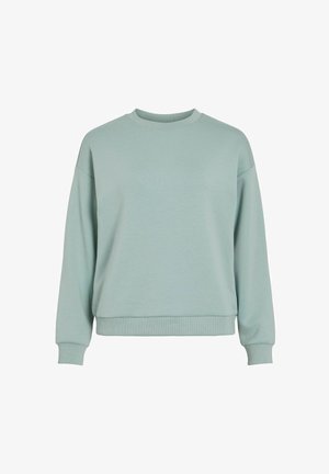 Svetlo zelena majica z okroglim izrezom, rebrastimi manšetami in sproščenim krojem. Narejena iz mehke tkanine z gladko teksturo.