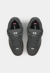 Black leather sneakers with gray laces, padded collar, and brown rubber outsole. Features logo on the tongue and side.