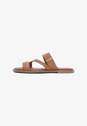 Sandales en cuir marron avec deux larges brides et une bride tressée. Semelle plate avec un léger talon, texture lisse et design minimaliste.