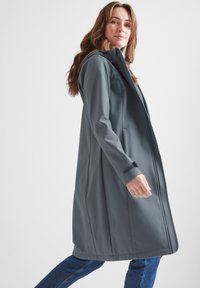 Long gray softshell coat with a hood, zip closure, side pockets, and adjustable cuffs. Smooth texture and straight silhouette.