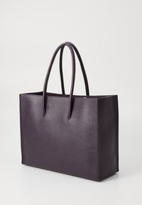 Purple leather tote bag with two handles, rectangular shape, textured surface, and open top. No visible hardware or patterns.