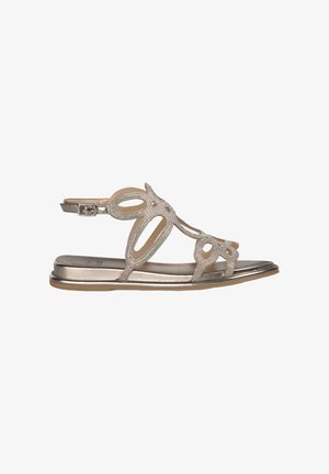 Metallic sandals featuring open toe design, decorative cutouts, and glitter accents on a flat sole. Adjustable ankle strap included.