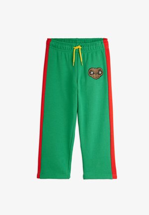 Zelene trenirke z rdečimi stranskimi črtami, ki imajo izvezeno značko lika E.T. in rumenim vrvico na elastičnem pasu.