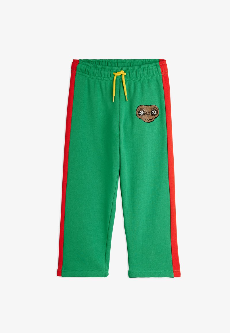 Zelené teplákové nohavice s červenými bočnými pruhmi, zdobené vyšitým nášivkom postavy E.T. a žltou šnúrkou na elastickom páse.