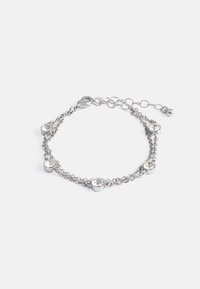 Bracelet en chaîne en argent avec cinq cristaux ronds transparents sertis dans le métal. Réglable avec une chaîne et un fermoir. Texture lisse.