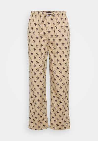 Beige pyjamabroekjes met een elastische tailleband en aantrekkoord. Heeft een herhalend bruin hondenpatroon over de volledige broek. Lichtgewicht stof, met rechte pijpen.