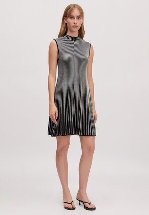 Black and white striped sleeveless dress with a high neck, featuring a flowy A-line silhouette and ribbed texture. Smooth bottom hem.