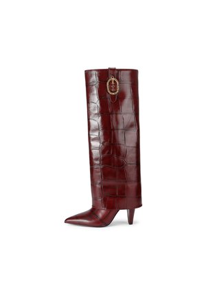 Botte montante en cuir synthétique crocodile bordeaux avec un bout pointu et un talon aiguille. Dotée d'éléments décoratifs en métal doré en haut.