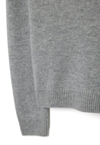 Gray knitted sweater with ribbed cuffs and hem, featuring a textured surface and a slightly loose fit.