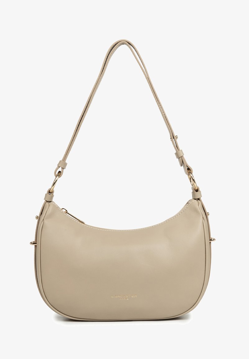 Sac à bandoulière en cuir beige à forme incurvée, avec une sangle réglable, des ferrures dorées et une fermeture éclair, arborant un marquage subtil à l'avant.