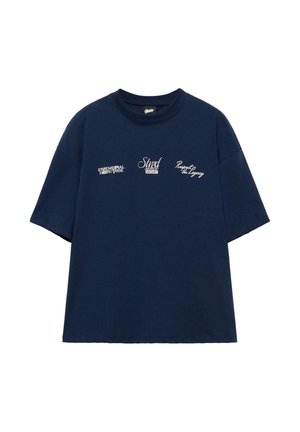 Tengerészkék rövid ujjú póló három fehér felirattal a mellkasán: "Ephemeral Heritage", "Stnd 1991" és "Respect the Legacy".