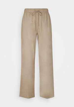 Pantalons larges beige clair avec une taille élastique et un cordon de serrage. Texture lisse, coupe droite, sans poches visibles ni motifs.