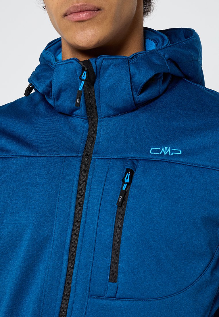 Chaqueta azul con capucha, hecha de una tela texturizada. Cuenta con un zipper negro, dos bolsillos con cierre y un logo bordado en el pecho.