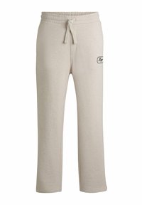 Beige joggingbroek met een relaxte pasvorm, elastische tailleband, trekkoord en zijzakken. Voorzien van een klein zwart logo op de dij.