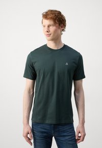 Dark green cotton t-shirt with short sleeves and a round neckline, featuring a small white logo on the left chest and a smooth texture.