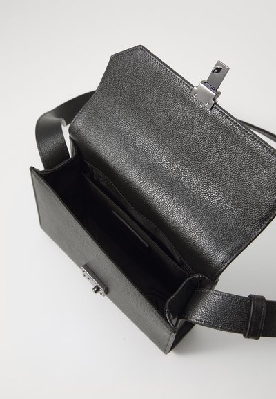 Black leather crossbody bag with a textured surface, rectangular shape, and metal clasp. Interior features a pocket and soft lining.