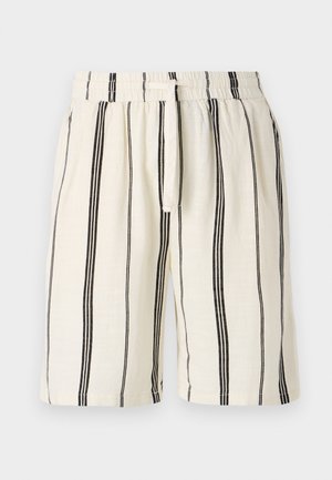 Linen shorts featuring a cream base with vertical black stripes, elastic waistband, and drawstring. Relaxed fit design, knee-length.