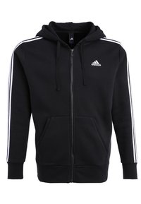 Sweat à capuche zippé noir Adidas avec des bandes blanches sur les manches, des poches avant, une capuche avec cordon et le logo Adidas sur la poitrine gauche.