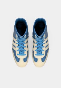 Textured high-top shoes with a blue leather upper, cream accents, and blue laces. Features three white stripes on the sides.