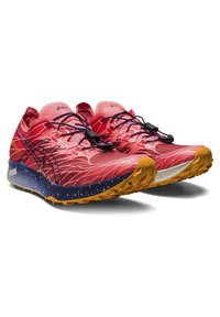 Red trail running shoes with a textured mesh upper, black laces, and a grip outsole featuring a yellow and navy blue accent.