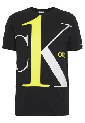 Czarny T-shirt z krótkim rękawem z dużą żółtą cyfrą "1" oraz dużymi białymi i szarymi literami "K", małym żółtym napisem "one", logo Calvin Klein na rękawie.
