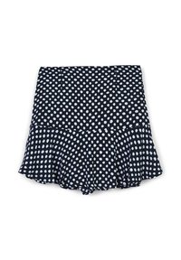 Gonna nera con orlo svasato, caratterizzata da un motivo a pois bianchi. Realizzata in tessuto leggero con una texture liscia.