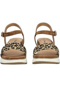 Leopard print sandals with a brown faux suede strap, ankle buckle closure, and white rubber sole. Open toe design with cushioned footbed.