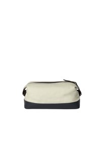 Beauty case in tela con parte superiore crema, parte inferiore blu scuro e dettagli in pelle. Caratterizzata da una chiusura con zip e maniglie laterali per un facile trasporto.
