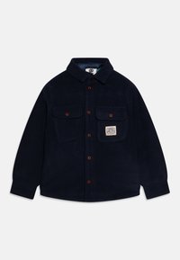 Navy fleece shirt jacket with a collar, two chest pockets, brown buttons, and a logo patch on the left pocket. Soft texture.