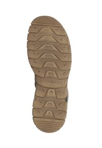 Semelle en caoutchouc marron avec un motif texturé. Comprend des nervures et des motifs pour l'adhérence. Se dégrade vers l'avant avec un bord arrondi.