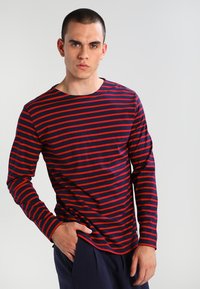 T-shirt a maniche lunghe a righe orizzontali blu navy e rosse, realizzato in morbido cotone, con collo girocollo e design aderente.