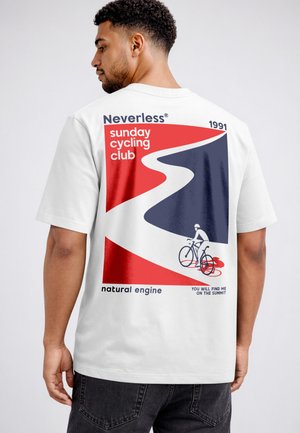 Man wearing white t-shirt with red and blue graphic of cyclist on winding road and text "sunday cycling club" on back.