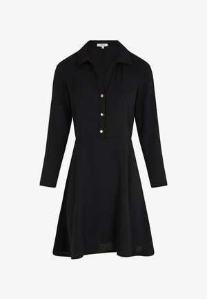 Schwarzes Kleid mit Kragen vorne, langen Ärmeln und fünf goldenen Knöpfen auf der Vorderseite. A-Linien-Silhouette aus einem strukturierten Stoff.