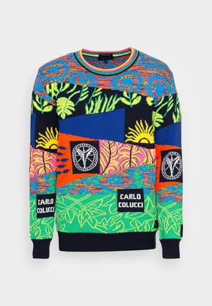 Maglione a maglia colorato con motivi floreali astratti e sole, con la scritta "Carlo Colucci" e loghi circolari sul petto e sulle maniche.
