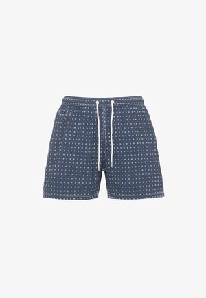 Costume da bagno blu navy con piccolo motivo paisley bianco, vita con coulisse bianca e patta sulla tasca posteriore.
