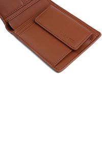 Brown leather wallet with a smooth texture, featuring multiple card slots and a flap pocket. Engraved logo on the interior.