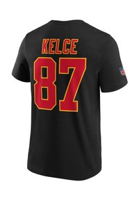 Camiseta de algodón negra con texto rojo y amarillo en la parte de atrás: "KELCE" y el número "87". Cuello redondo estándar con mangas cortas.