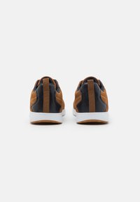 Brown and navy sneakers with a textured suede upper, leather accents, and white soles. Includes a rear pull tab and rubber outsole.
