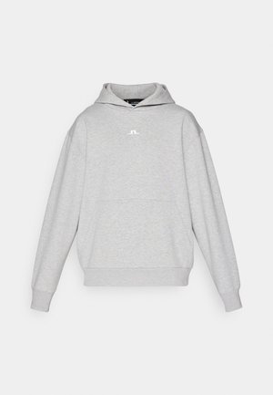 Grå sweatshirt med huva i mjukt stoff, med en ficka framtill, långa ärmar och dragsko i huvan. Litet logotyp tryckt på bröstet.