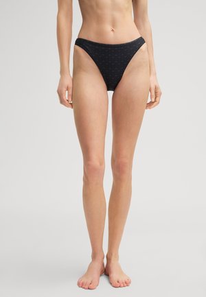 Black bikini bottom featuring a high-cut design, made from soft fabric with a subtle all-over pattern. High leg openings and minimal coverage.