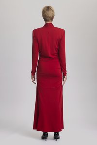 Μακρυμάνικο κόκκινο φόρεμα με ψηλό λαιμό, εφαρμοστό κορμό και ροή στο φούστα. Διαθέτει συγκεντρωμένο ντετέλ σχεδίασης κατά μήκος των πλαινών και ψηλό σκίσιμο.
