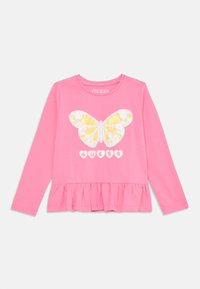 Long-sleeve pink t-shirt featuring a large white and yellow butterfly graphic with heart accents and a ruffled hemline. Brand logo included.