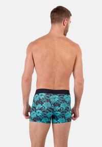 Men's floral print boxer briefs featuring a navy background with turquoise flowers and a textured waistband. Breathable fabric for comfort.