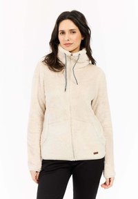 Beige fleece jack met hoge kraag, volledige rits en zakken; heeft elastische trekkoorden en een zachte, gestructureerde stof.
