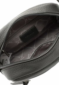 Round gray leather bag with a textured exterior, silver zipper, and a patterned fabric interior featuring a small zipper pocket.