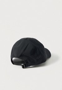 Black cap with a curved brim, made from lightweight fabric. Features a rear adjustable strap and a button on top. Smooth texture.