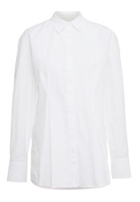 Chemise blanche à manches longues en tissu léger, dotée d'un col boutonné, d'une patte de boutonnage devant et d'une coupe droite avec des fentes sur les côtés.