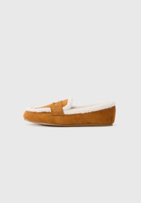 Tan suede slipper with white fur lining, slip-on design, flat sole, and decorative stitching on the upper. Soft texture and rounded shape.