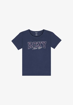 T-shirt bleu marine avec le mot "ROXY" en lettres audacieuses, avec un motif floral et "Depuis 1990" en cursive en dessous.