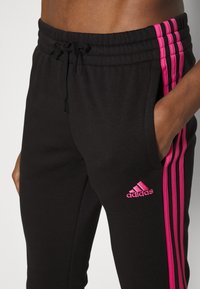 adidas Sportswear Teplákové kalhoty - black